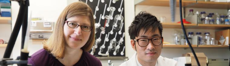 student and professor posing in a laboratory
