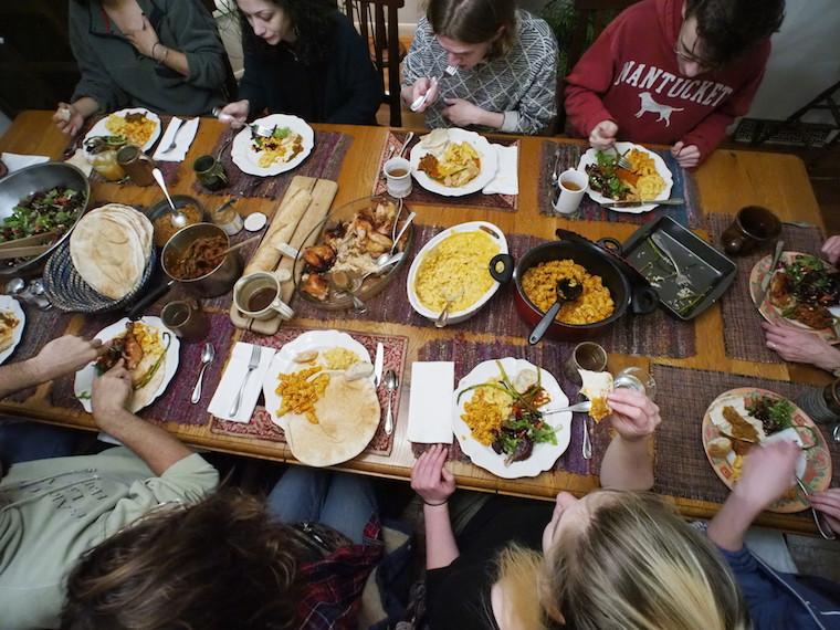 Students eating a meal at a potluck.