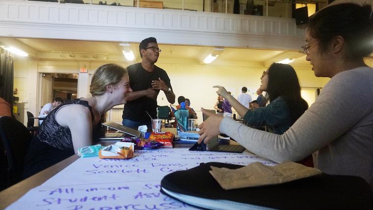 Students talking at a table.