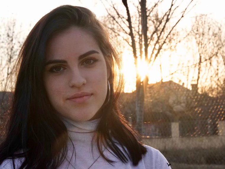 woman with sunset in background.