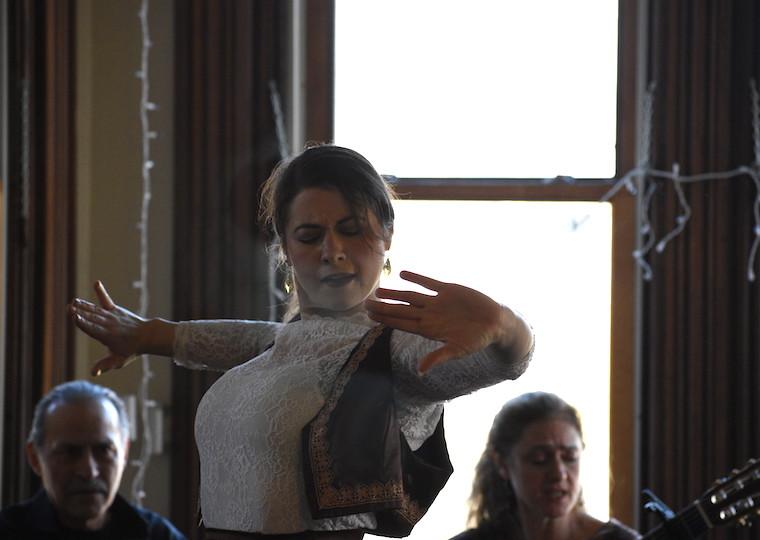 A woman looks intense with outstretched hands.