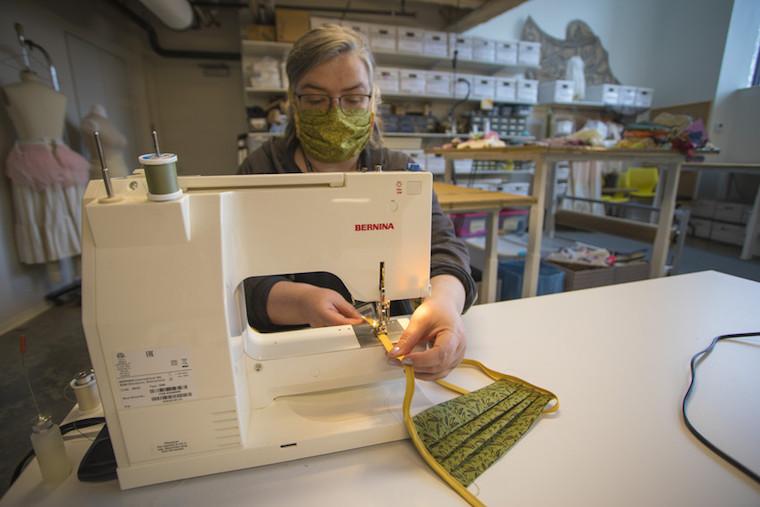 Woman using a sewing machine.