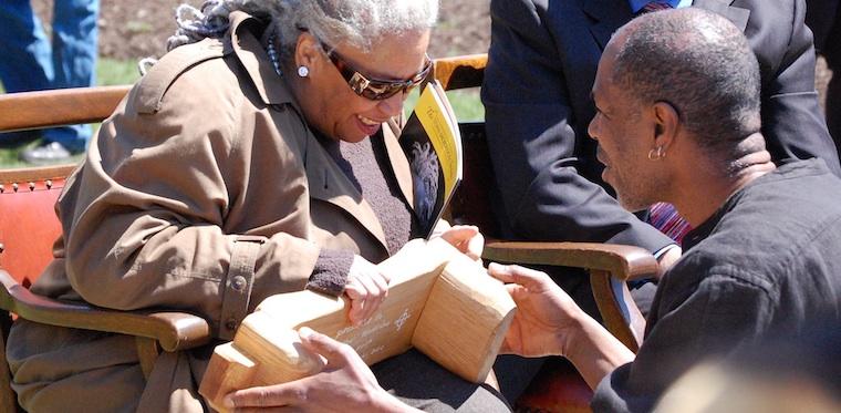 Woman seated at bench.