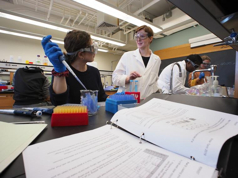 Student and professor work in chemistry lab.