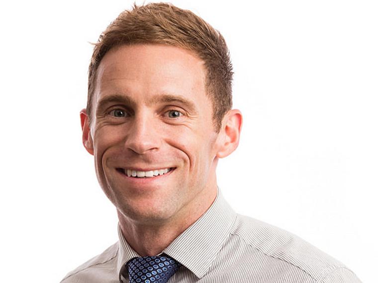 Michael Rainaldi in collared shirt smiling.