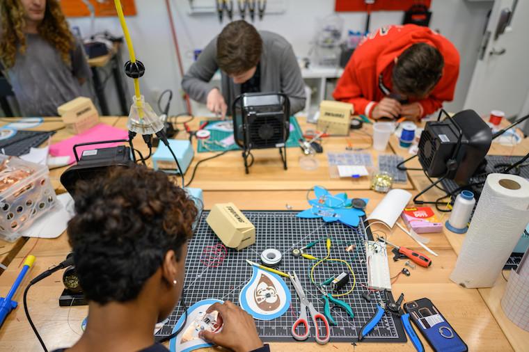 Students and professor work on audio projects.