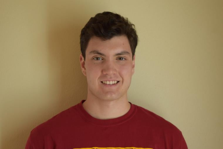 Man smiling in red T-shirt.