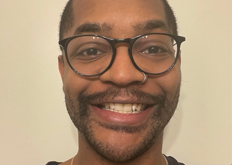 A portrait of a man wearing glasses.