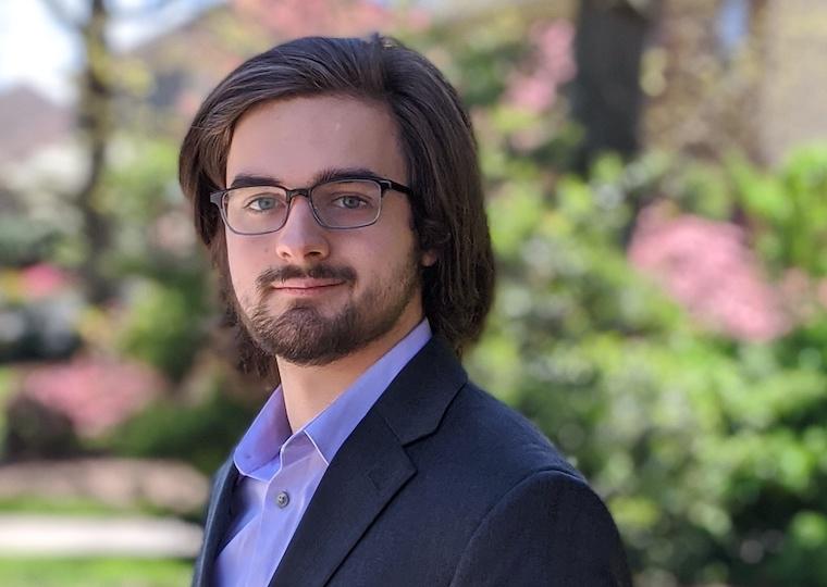 A portrait of a young man in a suit.