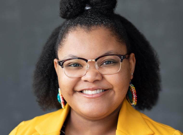 A portrait of a female student wearing glasses.