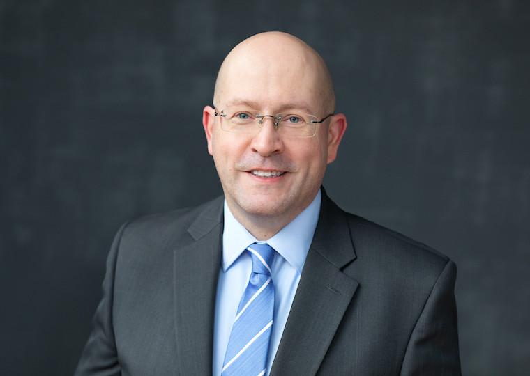 A portrait of a man in a suite.