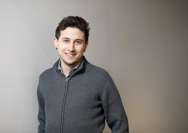 A portrait of a male student wearing a sweater.