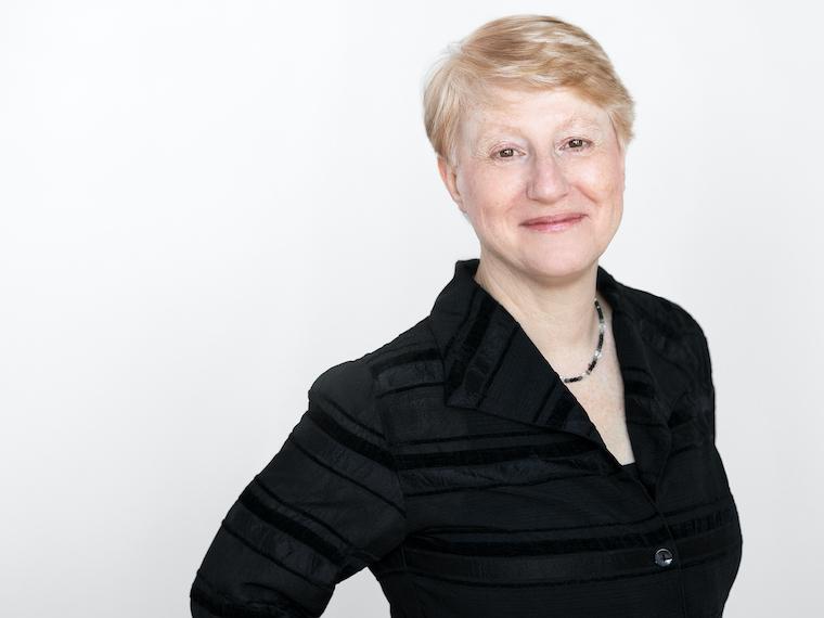 A portrait of a woman with her hands on her hips.