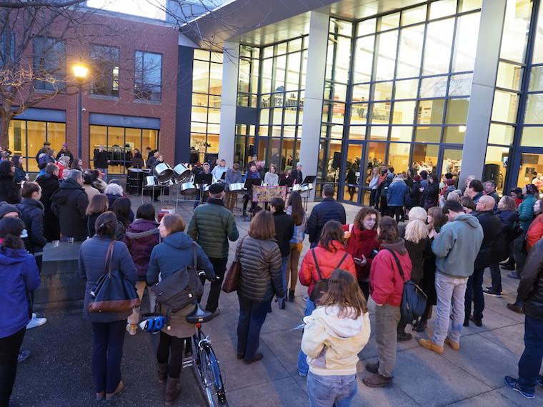 Parents and students gather in the courtyard to listen to a band.