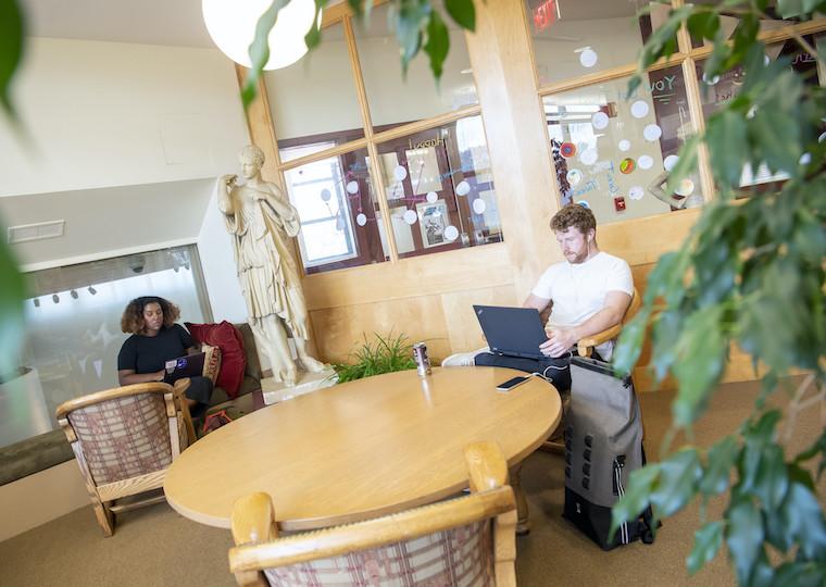 Two students study in a reading nook.