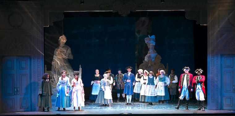 A stage production with people dressed in Victorian attire.