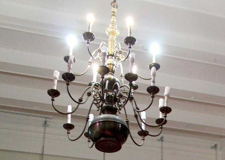A large silver chandelier hanging from a white ceiling