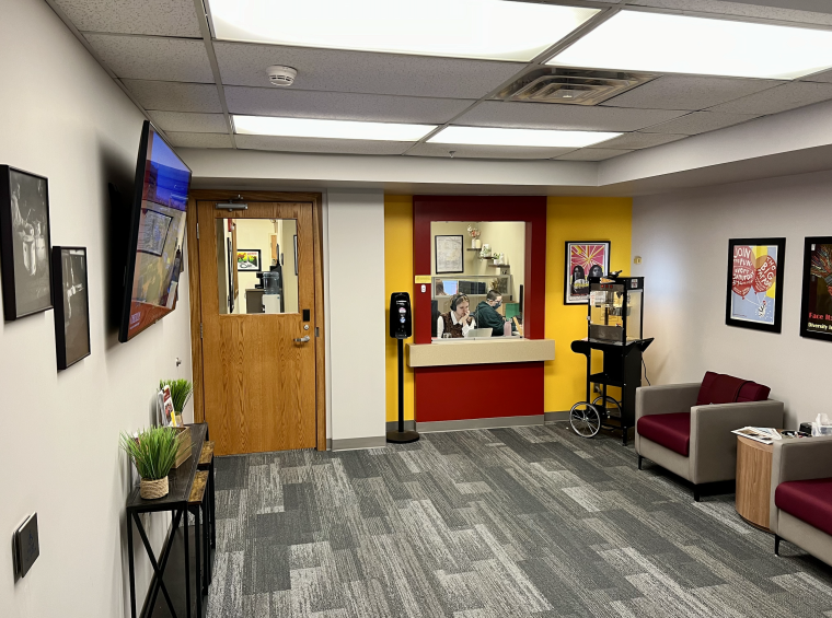 Lobby room of HR Office showing front desk and two student workers