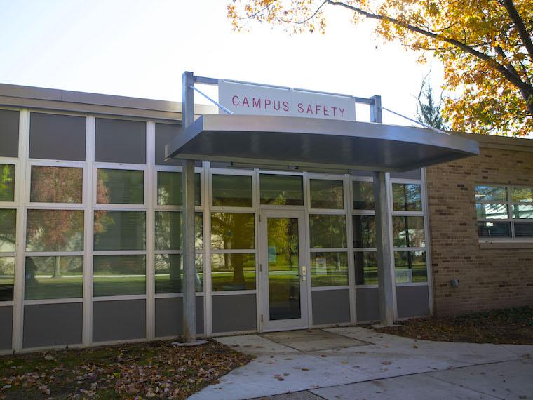exterior view of campus safety building with big sign above the doorway.