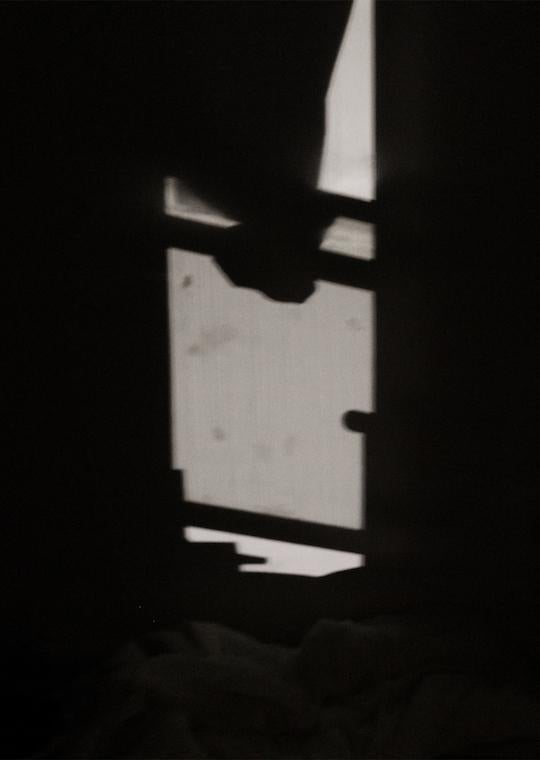 A curtain in a dark room.