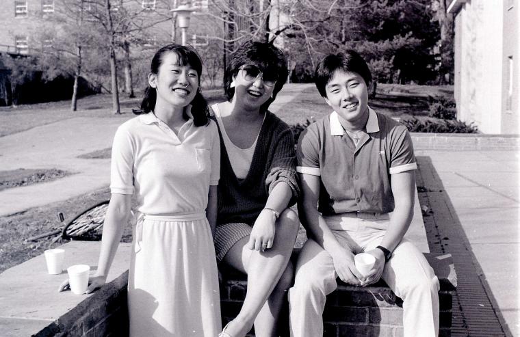 Three students smile for the camera.