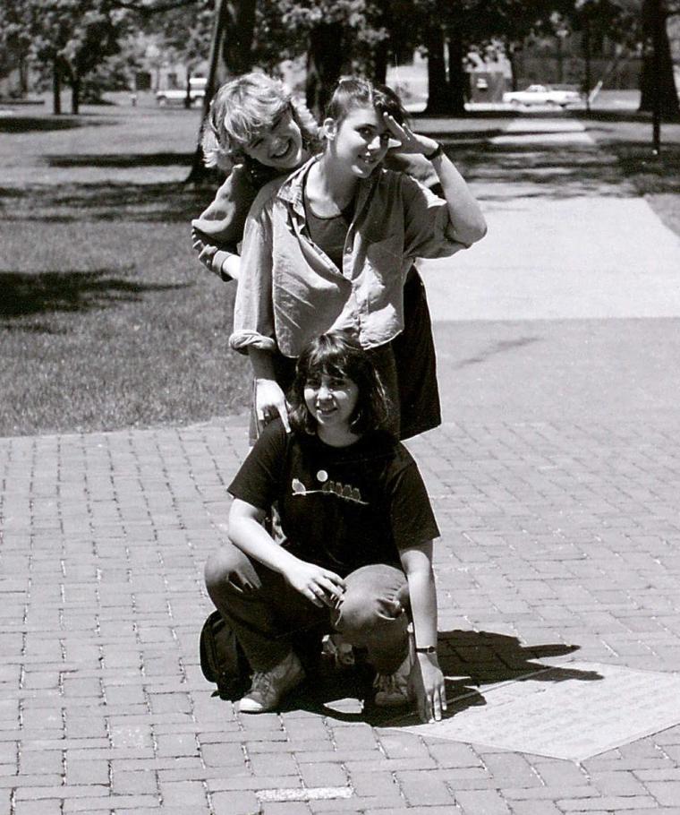 Three female students posing for a photo on campus.