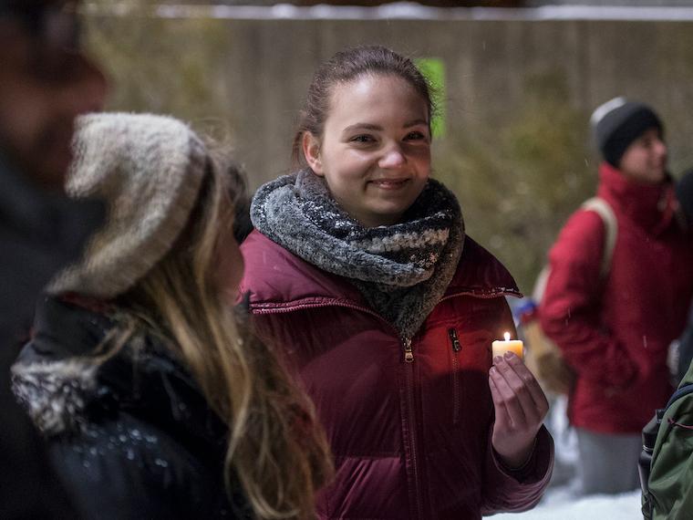 A student holding a candle.