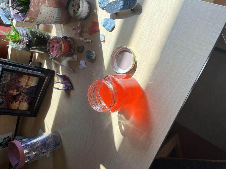 A glowing red drink on a desk