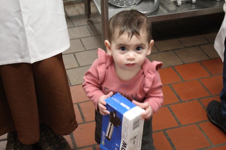 a baby holds a box that reads "blowtorch"