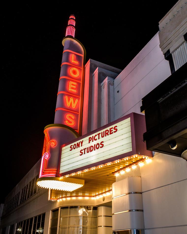 Loews theater sign fully lit at night, with Sony Pictures Studios on the marquee.