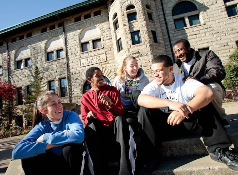 Students sitting together in front of Warner Center. 