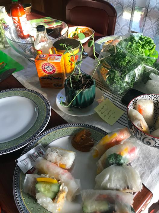dining table covered in ingredients to make spring rolls