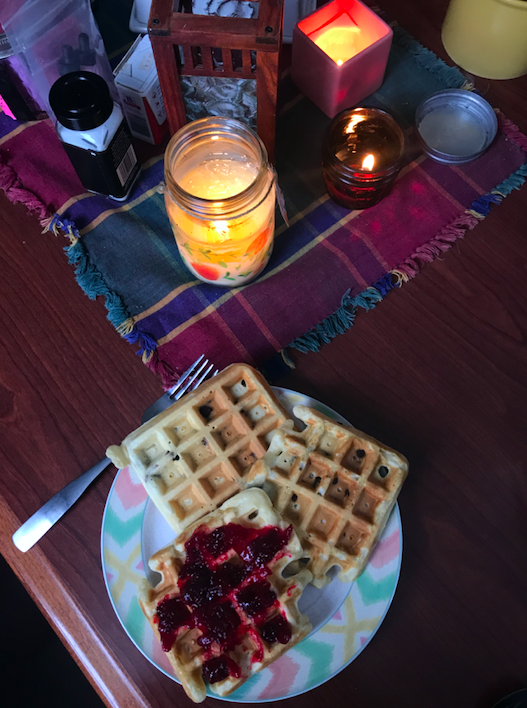 dining table with waffles and candles on it