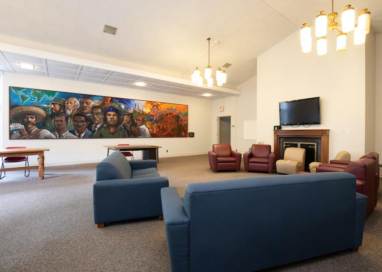 A large lounge with a mural on the back wall.